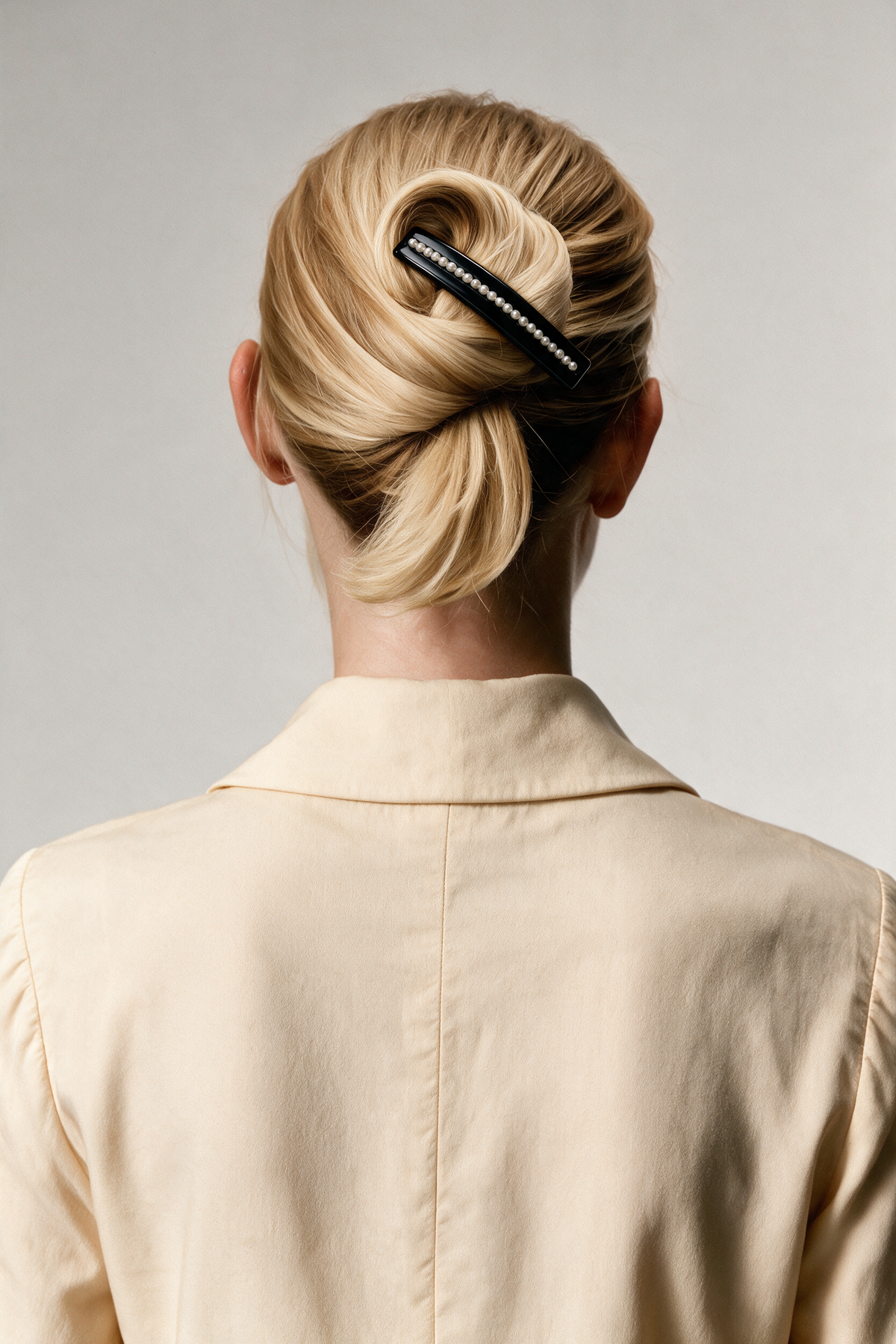 Black Pearl River Barrette worn diagonally across a blonde French twist.