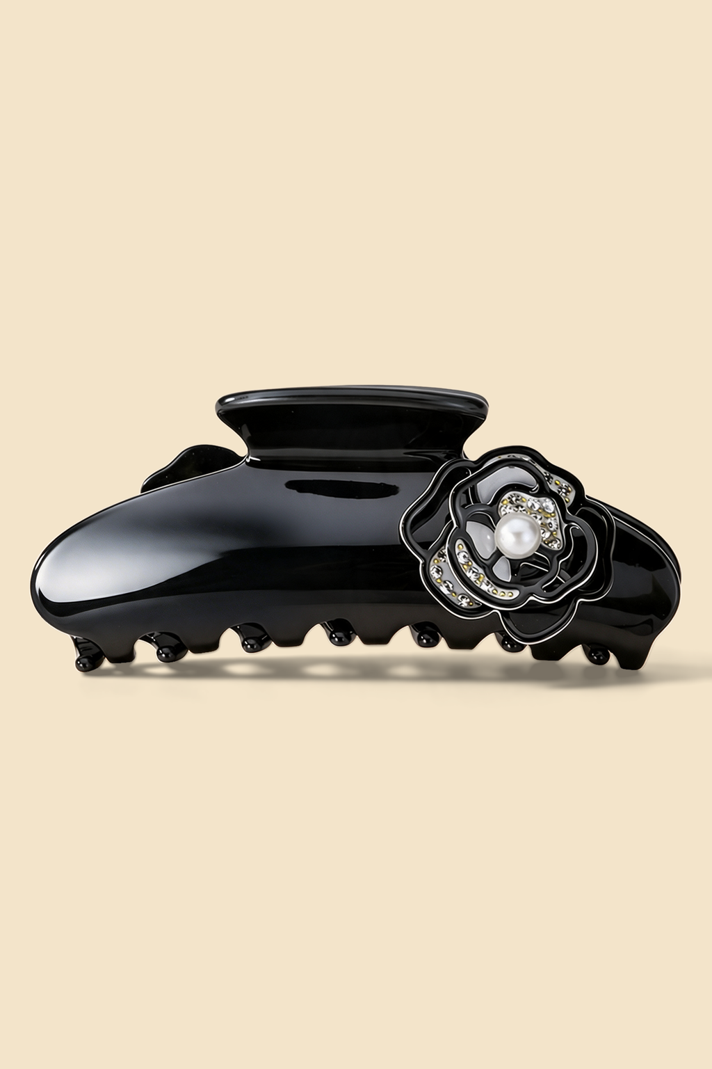 Camellia Claw Clip in Black, with a glossy black body and pearl-effect floral centre.