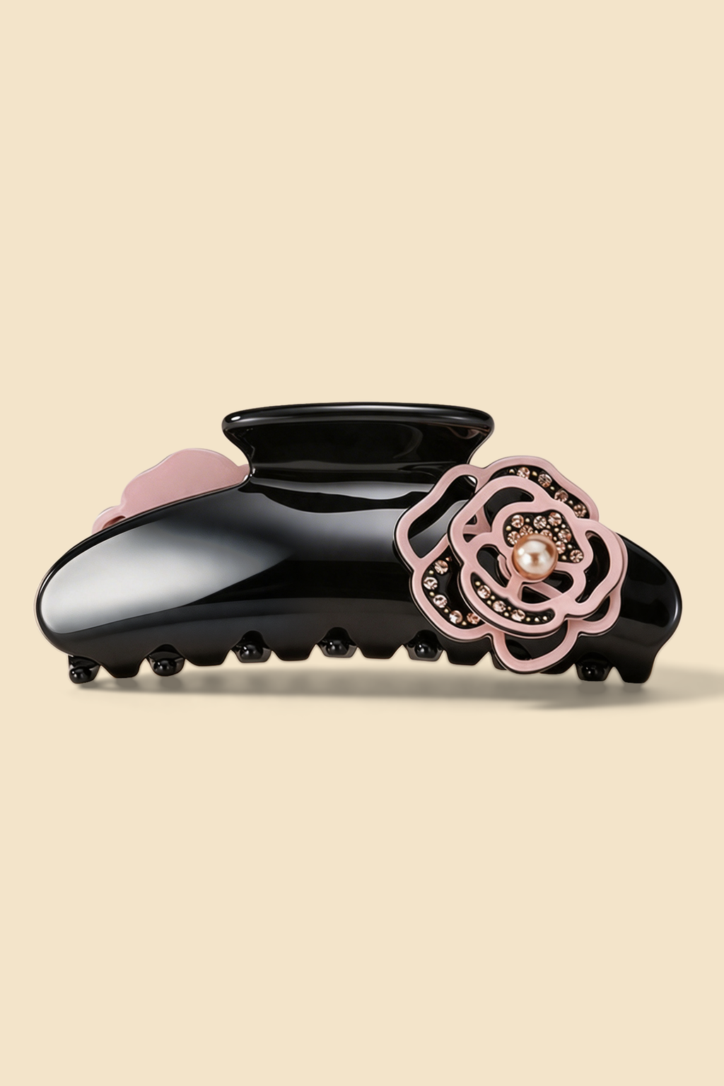 Camellia Claw Clip in Pink, with a glossy black body and pink camellia ornament.