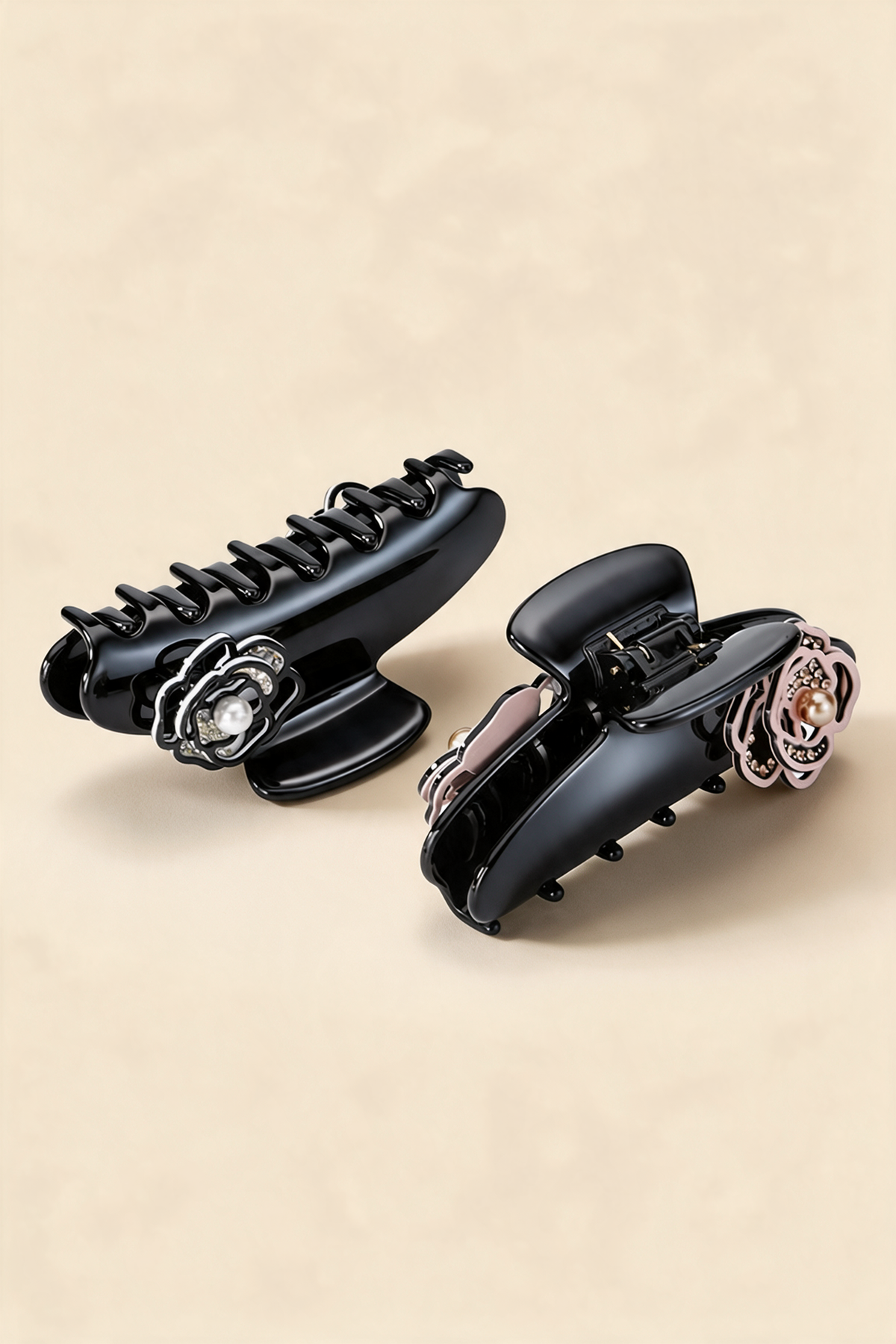 Two Camellia Claw Clips showing their curved teeth and floral ornaments.