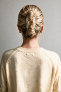 Ivory Halo Claw Clip holding a blonde French twist, viewed from behind.